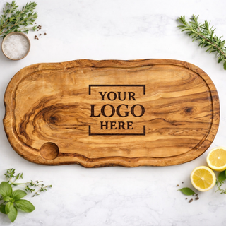 Olive wood carving board for personalized logo engraving on a marble surface with kitchen items perfect for client gifts, branding, realtors and closing gifts