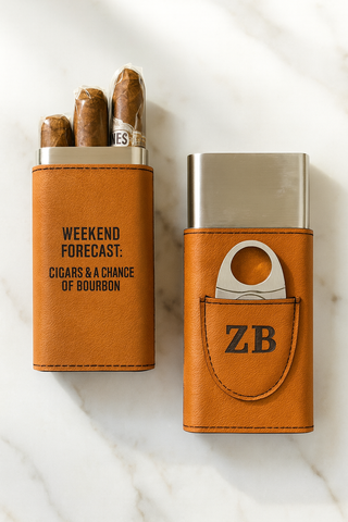 Cigar case with 'Weekend forecast: Cigars & a chance of bourbon' text and a cutter on a marble surface.