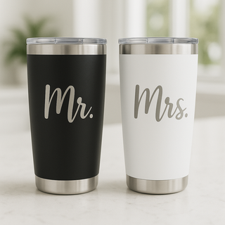 Two tumblers, one black with 'Mr.' and one white with 'Mrs.' on a light background.